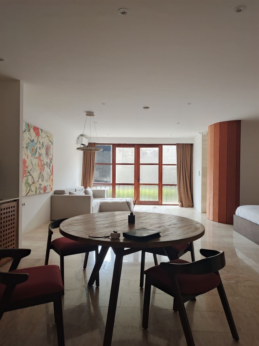 Open-plan dining room with floor-length curtains