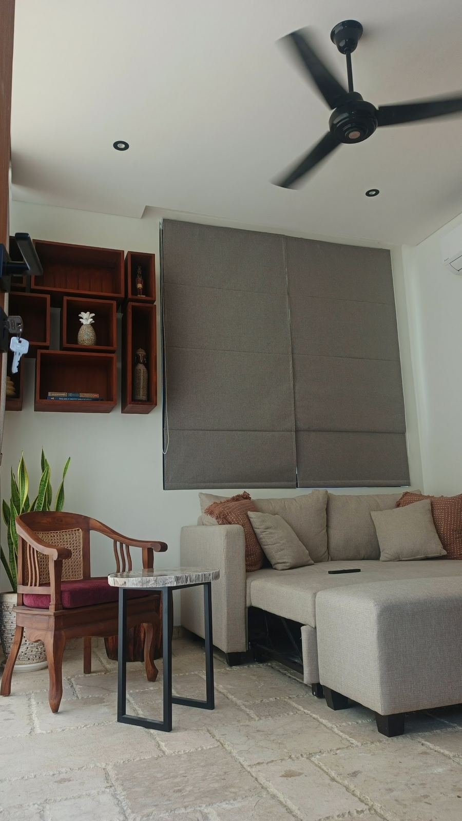 Grey chaise sofa under grey roman blinds